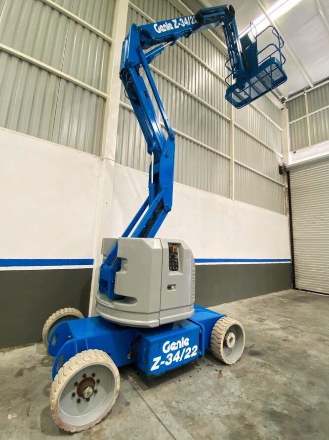 Blue Genie Z-34/22 lift parked indoors, with extended boom arm and basket.